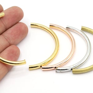 May include: Four open-ended metal hoops in gold, rose gold, silver, and brass.