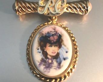 Broche colgante con camafeo del Club Presidente de Avon vintage firmado en tono dorado, años 90