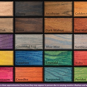May include: A chart of 20 wood stain colours, including Plain, Ebony, Jacobean, Golden Oak, Western Oak, Kona, Dark Walnut, Red Mahogany, Mystic, Gloomful Fog, Blue Mist, Sunbleached, Citrine, Sapphire, Emerald, Ruby, Cherry Blossom, Creedite, Turquoise, and Peridot. *Colours are a close approximation from how they may appear in person due to varying monitor displays and wood grain.