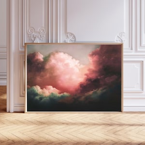 May include: A framed painting of a dramatic, colorful sunset with pink, purple, and green clouds. The clouds are thick and fluffy, and the sky is a deep blue. The painting is framed in a simple, gold frame.