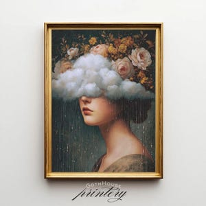 May include: A framed art print featuring a woman's profile, her eyes obscured by a cloud. A floral arrangement of roses and other flowers crowns her head. The artwork has a vintage aesthetic, with the text "GOTH HOUSE printery" at the bottom.