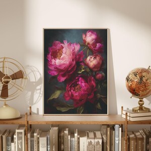 May include: A framed floral print featuring a bouquet of vibrant pink peonies against a dark teal background. The painting has a soft, painterly style with visible brushstrokes. The artwork is displayed on a wooden shelf with books and decorative items.