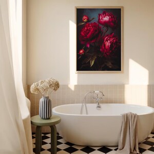 May include: A framed floral art print featuring vibrant red peonies against a dark background. The artwork is displayed above a white bathtub in a bathroom setting. A vase with dried flowers and a small stool are also visible.