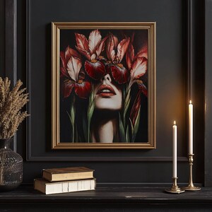 May include: A framed painting of a woman's face with red iris flowers covering her eyes. The flowers are in shades of red, pink, and white, and the background is dark.
