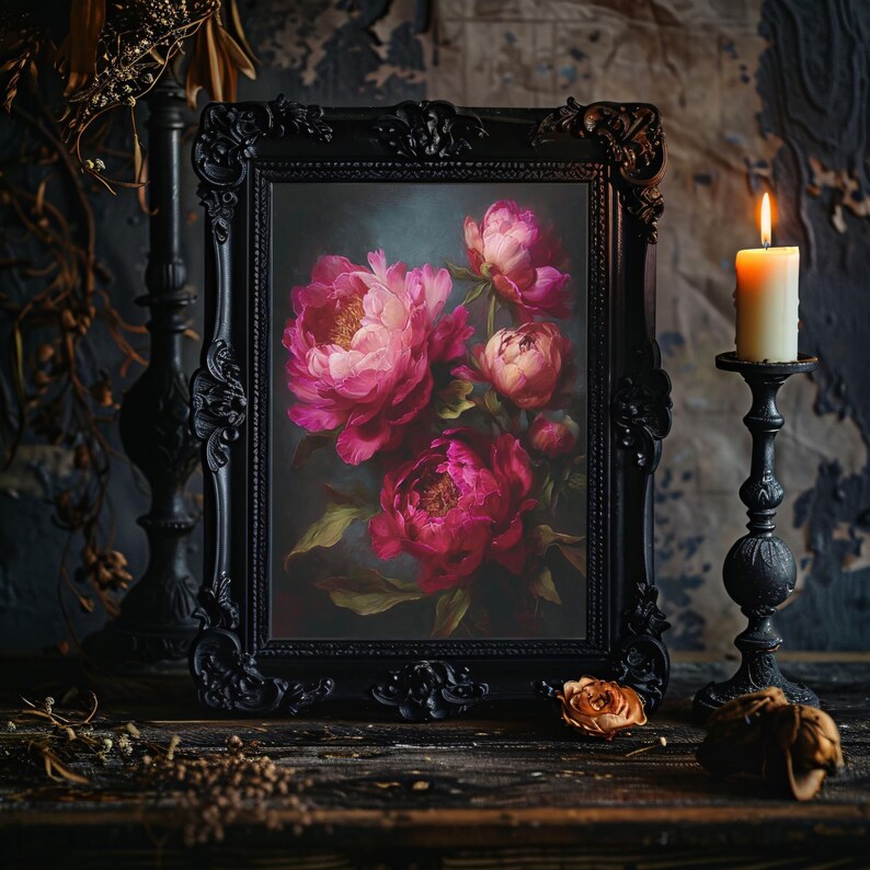 May include: A framed floral painting featuring vibrant pink peonies. The artwork is set in a black ornate frame, with a lit candle and decorative candle holder to the right. The scene is set on a dark wooden surface.