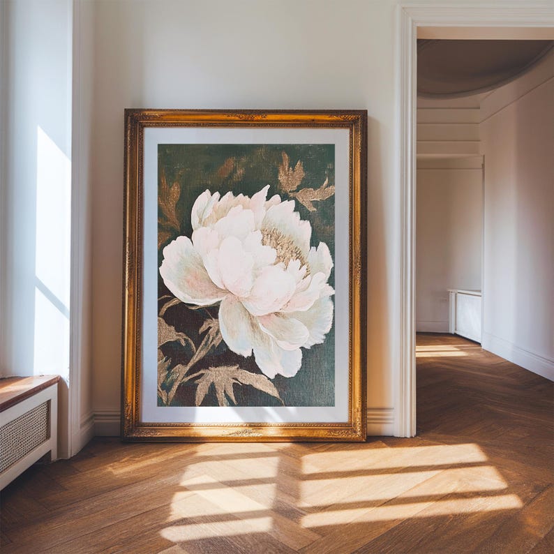May include: A framed print of a large, white peony flower with gold accents on a dark green background.