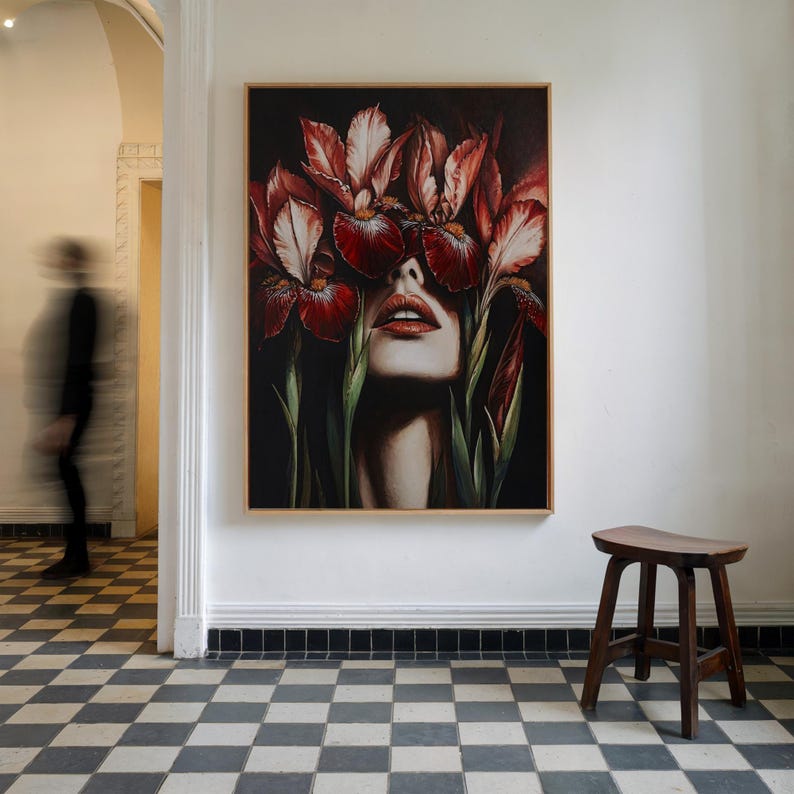 May include: A painting of a woman's face with red and white iris flowers covering her eyes. The flowers are in focus, and the woman's face is blurred in the background. The painting is done in a realistic style.