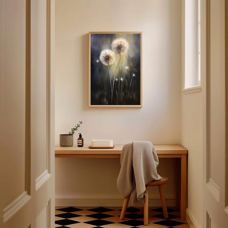 May include: A framed painting of two dandelions in a field, with a dark background and a wooden frame. The painting hangs above a wooden desk with a small chair and a patterned floor.