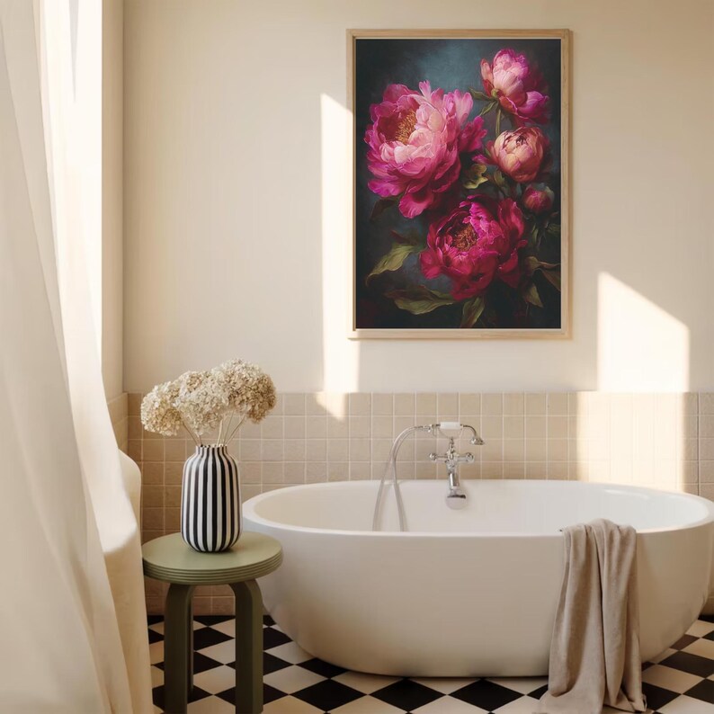 May include: A framed floral painting featuring vibrant pink peonies with green leaves. The artwork hangs above a white bathtub in a bathroom with a black and white checkered floor. A vase with dried flowers sits on a small green stool.