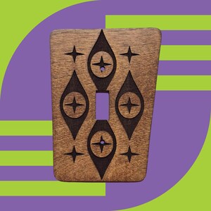 May include: A wooden light switch cover with a mid-century modern design featuring a geometric pattern of diamonds and stars.