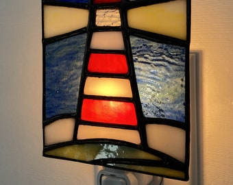 Stained glass plug in night light lighthouse, adds a touch of elegance and artistic flair to the coastal motif.