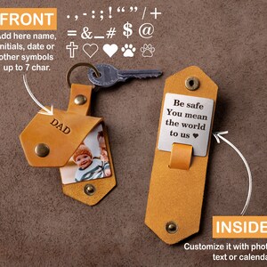 May include: A tan leather keychain with a metal key. The front of the keychain is embossed with the word "DAD" and holds a photo. The inside has a metal plate with the text "Be safe You mean the world to us".