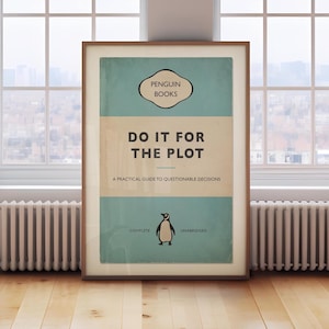 May include: Framed print with a retro book cover design. The cover is split into light blue and beige sections, with the title "DO IT FOR THE PLOT" in large text. A penguin illustration is at the bottom, with the words "COMPLETE" and "UNABRIDGED".