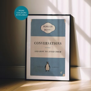 May include: A framed print of a vintage Penguin Books cover featuring a blue background with white text that reads "Conversations and How to Avoid Them". The cover also features a penguin illustration and the text "Penguin Books" in a white oval.
