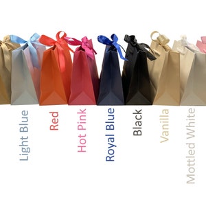 May include: Assortment of ten gift bags in various colours, including natural kraft, light blue, red, hot pink, royal blue, black, vanilla, mottled white, and light pink. Each bag has a matching ribbon tied around the handles.