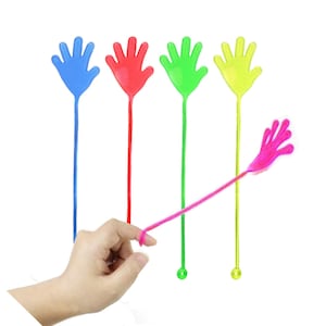 May include: Five colourful plastic hand toys on sticks. The hands are blue, red, green, yellow and pink. The sticks are all the same length and have a small loop at the bottom.