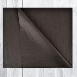 May include: A sheet of dark brown tissue paper, folded in half, with a smooth, slightly textured surface.