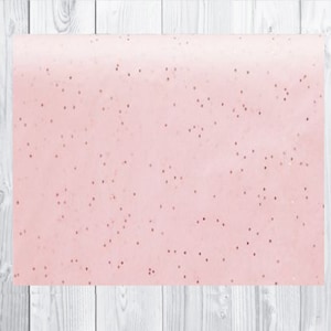 May include: A sheet of pink wrapping paper with a subtle glitter pattern. The paper has a light pink ombre effect.
