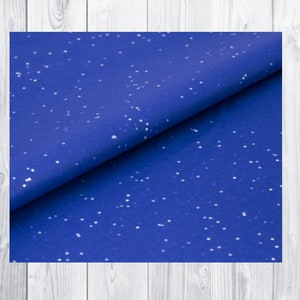 May include: Blue tissue paper with white speckles. The paper is folded in half and the white speckles are visible on both sides.