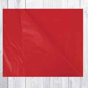 May include: A solid red sheet of paper. The paper is slightly wrinkled and has a glossy finish.