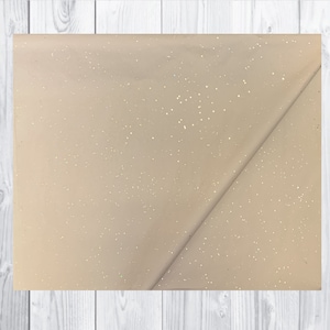 May include: A sheet of beige tissue paper with a subtle shimmer of gold glitter.