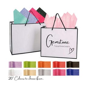 May include: White gift bags with black handles and the text "Gemstone Tissue Paper Sheets" and a heart symbol. The bags are filled with tissue paper in various colours, including pink, blue, green, and purple. The text "20+ Colours to choose from..." is below the bags.
