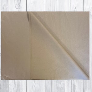 May include: A sheet of brown tissue paper, folded in half, with a slight sheen.