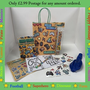 May include: A party bag filled with gaming themed items, including a colouring book, stickers, a pencil, a ruler, and a blue balloon. The bag is decorated with a gaming theme and the text "High Score".