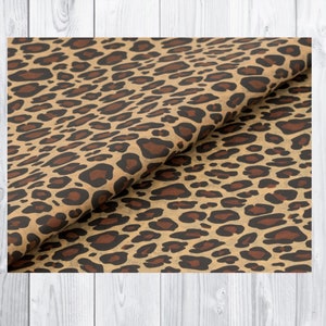 May include: Brown tissue paper with a leopard print pattern. The paper is folded in half, showing the pattern on both sides.