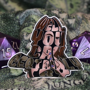 May include: A sticker with a woman's face in the center, the words "Well you can certainly try" are written around her face. The sticker is on a green and brown fabric background with two purple dice.