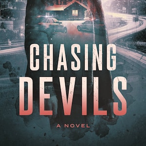 May include: A book cover with a man in a dark jacket and a baseball cap. The man is standing in front of a city skyline with a house and trees superimposed over him. The title of the book is "Chasing Devils" and the subtitle is "A Novel".
