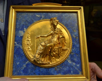 Brass frame and lapis lazuli with bas-relief in gilded brass