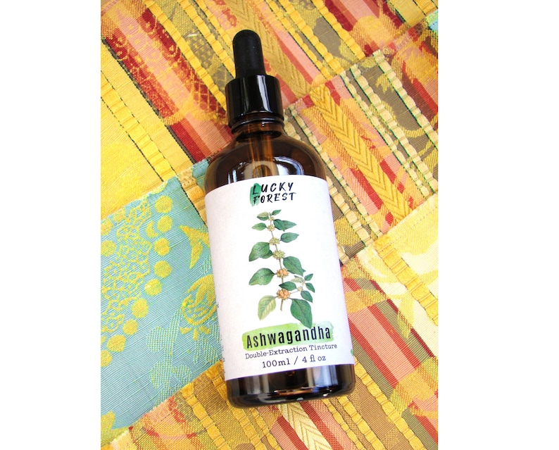 May include: A brown glass bottle with a black dropper, labeled "Lucky Forest." The label features a green illustration of a plant and the word "Ashwagandha." The bottle contains 4 fl oz of double extraction tincture.