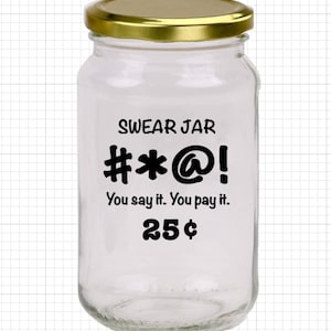 May include: A clear glass jar with a gold lid. The jar has a black label that says "SWEAR JAR #*@! You say it. You pay it. 25¢".