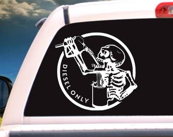 May include: A white decal sticker of a skeleton drinking from a gas can with the text "Diesel Only" in a circle around it.