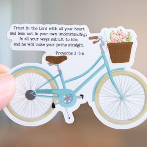 May include: A die-cut sticker featuring a light blue bicycle with a brown seat and a brown front basket filled with pink and white flowers. The text reads: Trust in the Lord with all your heart and lean not in your own understanding; in all your ways submit to him, and he will make your paths straight. -Proverbs 3:5-6.