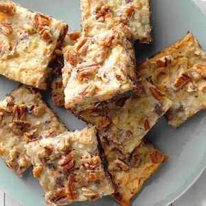 May include: A plate of coconut pecan bars, a sweet treat with a crunchy texture. The bars are golden brown and have a light, fluffy texture.