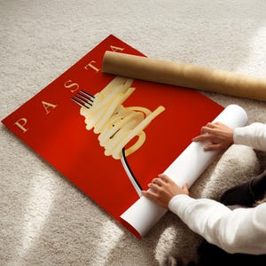 A person is rolling up a red poster with the word "PASTA" on it, which features a stylized image of spaghetti noodles.
