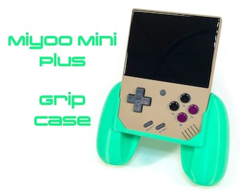 May include: A green handheld game console grip case for the Miyoo Mini Plus. The case has two green grips on the sides and a gold console with a black screen in the middle. The console has buttons labeled "Select", "Start", "A", "B", and "Y".