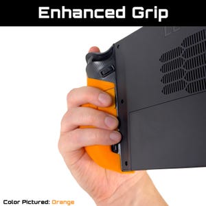 May include: An orange and black gaming device grip is held in a hand. The grip is attached to a black device with vents. The text "Enhanced Grip" is at the top of the image, and "Color Pictured: Orange" is at the bottom.