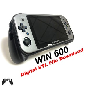 May include: A silver handheld gaming console with black accents and a screen displaying the text "ANBERNIC". The console has a black case with a textured surface. The text "WIN 600 Digital STL File Download" is printed in red on a white background.