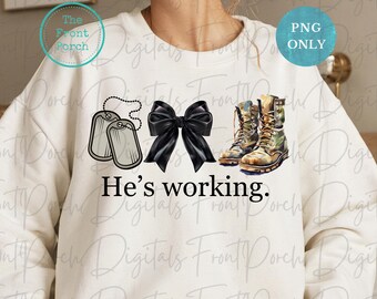 May include: A white sweatshirt featuring a black bow, two silver dog tags, and a pair of camouflage boots. The text "He's working." is printed on the sweatshirt.