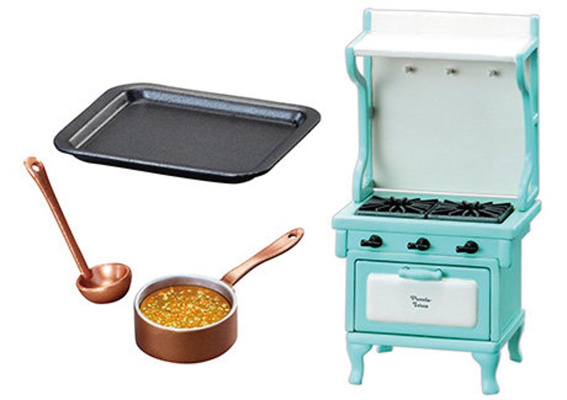 May include: A miniature kitchen set with a blue and white stove, a copper pot with a ladle, and a black baking sheet.