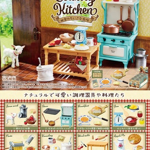 May include: A miniature country kitchen playset with a blue stove, a wooden table, and a white farmhouse sink. The set includes miniature food items, kitchen utensils, and a small white lamb figurine. The packaging features the text "Country Kitchen" and "田舎のちいさな台所" in Japanese.