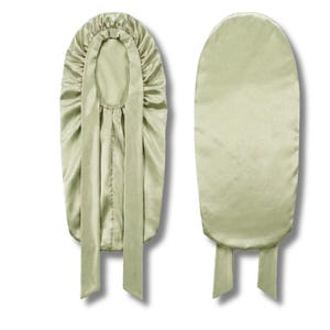 May include: Two sage green satin bonnets are shown. One is open, displaying the inside, with a gathered crown and long ties. The second bonnet is closed, showing the smooth exterior and ties at the base. The bonnets are designed to protect hair.