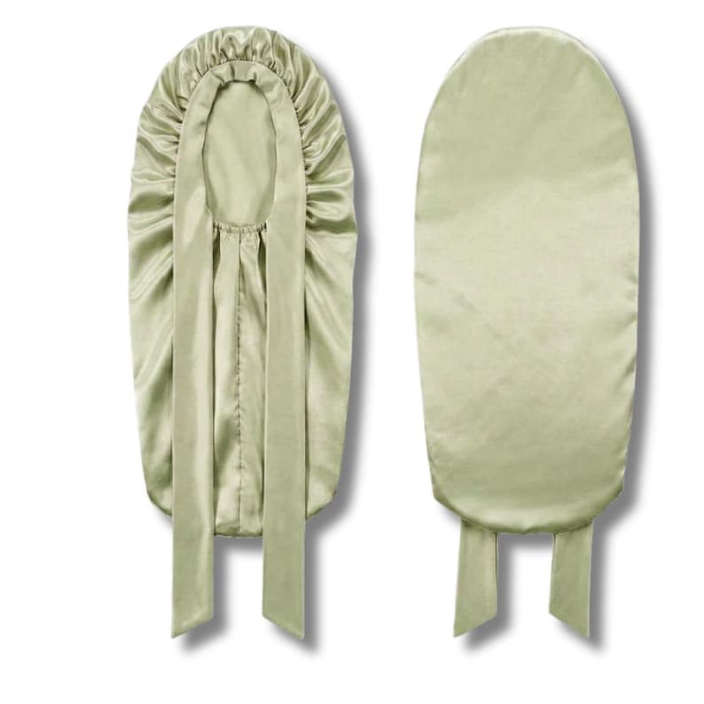 May include: Two sage green satin bonnets are shown. One is open, displaying the inside, with a gathered crown and long ties. The second bonnet is closed, showing the smooth exterior and ties at the base. The bonnets are designed to protect hair.