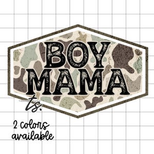 May include: A hexagonal design with the words "BOY MAMA" in distressed black lettering. The background features a camouflage pattern in shades of green, brown, and beige. The text "2 colors available" is written in black script.