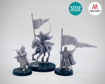 May include: Three unpainted miniature figures, two standing and one on horseback, holding flags with intricate designs. The figures are wearing robes and holding swords. The figures are on circular bases.