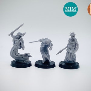 May include: Three grey plastic miniature figures of ghostly figures, each with a sword and wearing a flowing robe. The figures are standing on black bases.