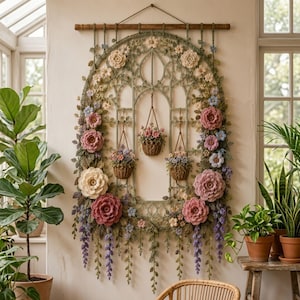May include: A large, arched wall hanging featuring intricate crochet work in shades of green, pink, cream, and blue. The piece includes three small hanging baskets filled with crocheted flowers, surrounded by floral vines and hanging wisteria.